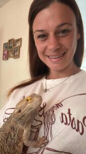 Nathalie holding Toothless the bearded dragon